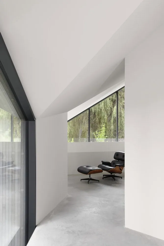 Re-folded House Lounge Nook Eames Window by McLeod Bovell Modern Houses Re-folded House by McLeod Bovell Modern Houses, lounge nook with Eames chair by window, Vancouver