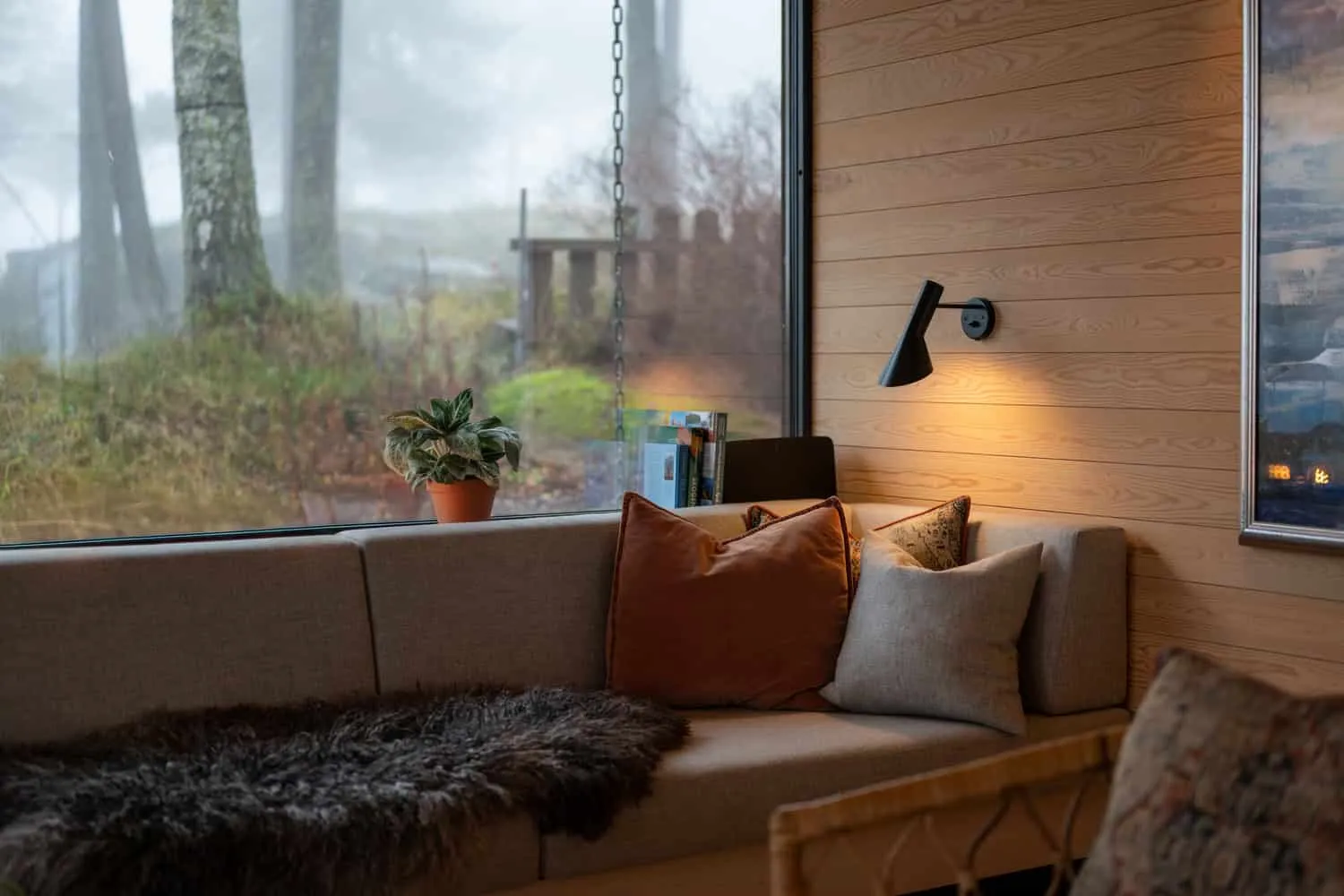 Solem Forest House Sofa Window Close-Up – MORFEUS arkitekter Solem Forest House by MORFEUS arkitekter, sofa nook with pillows and large picture window