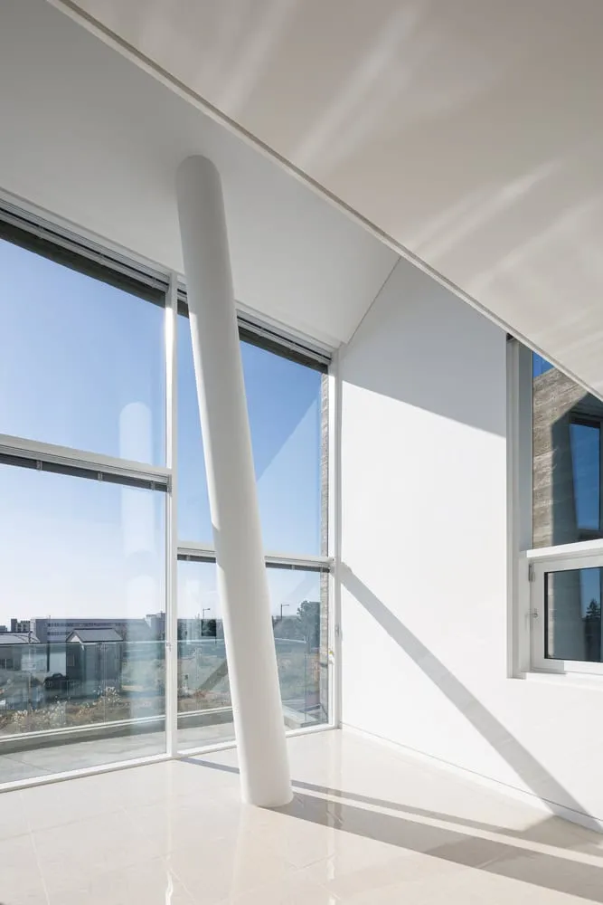 Pacific Residence Tilted Column Corner Window by Moon Hoon Weißer, schräger Pfeiler neben dem Eckfenster der Pacific Residence von Moon Hoon in Seogwipo