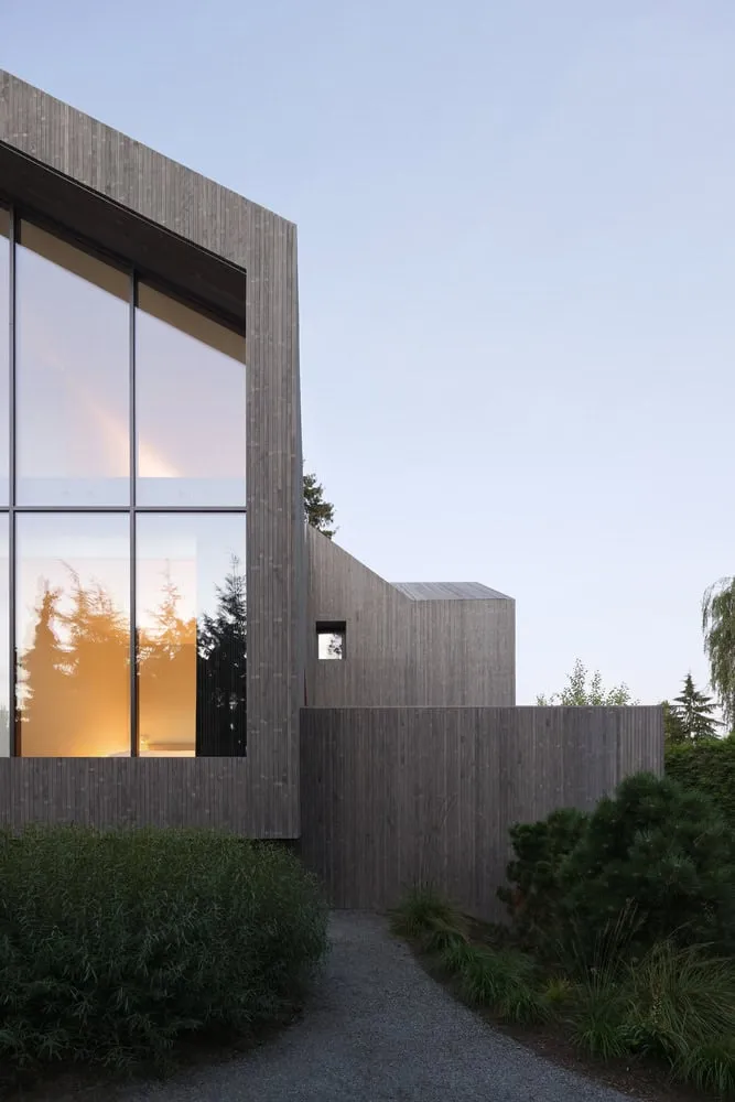 Re-folded House Side Gable Evening by McLeod Bovell Modern Houses Re-folded House by McLeod Bovell Modern Houses, side gable exterior at evening, Vancouver