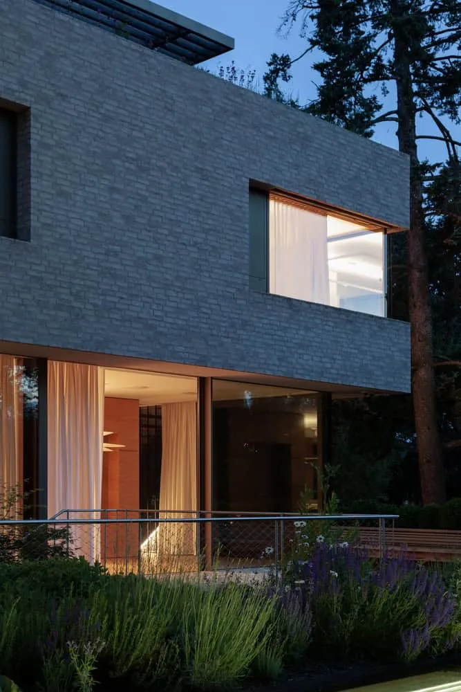 Fassadenausleuchtung des Nachtgartens der Villa Vista von Znameni Ctyr Architekti Villa Vista von Znameni Ctyr Architekti, Fassade des Nachtgartens mit sanftem Landschaftsbild und Fassadenausleuchtung