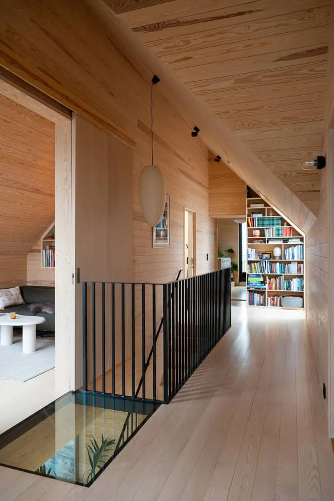 Solem Forest House Upper Hallway Bookshelves – MORFEUS arkitekter Solem Forest House by MORFEUS arkitekter, upper hallway with custom bookshelves and timber walls