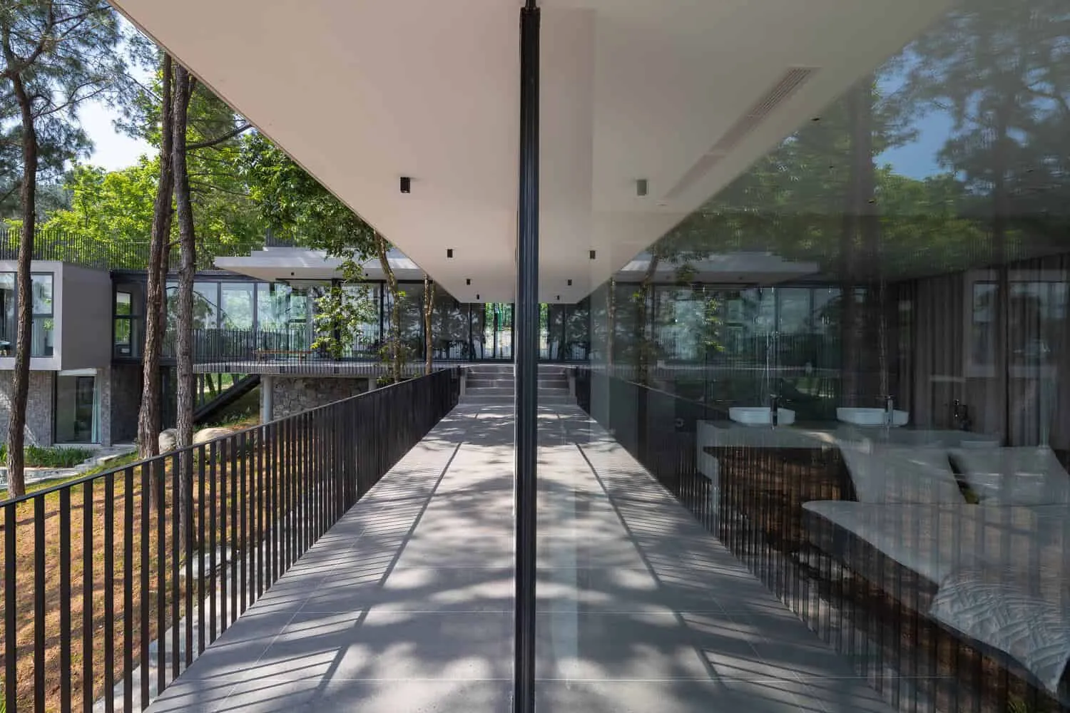 Tam Dao Retreat House pine forest elevation by Idee architects Tam Dao Retreat House by Idee architects elevation screened by pine forest in Tam Dao, Vietnam