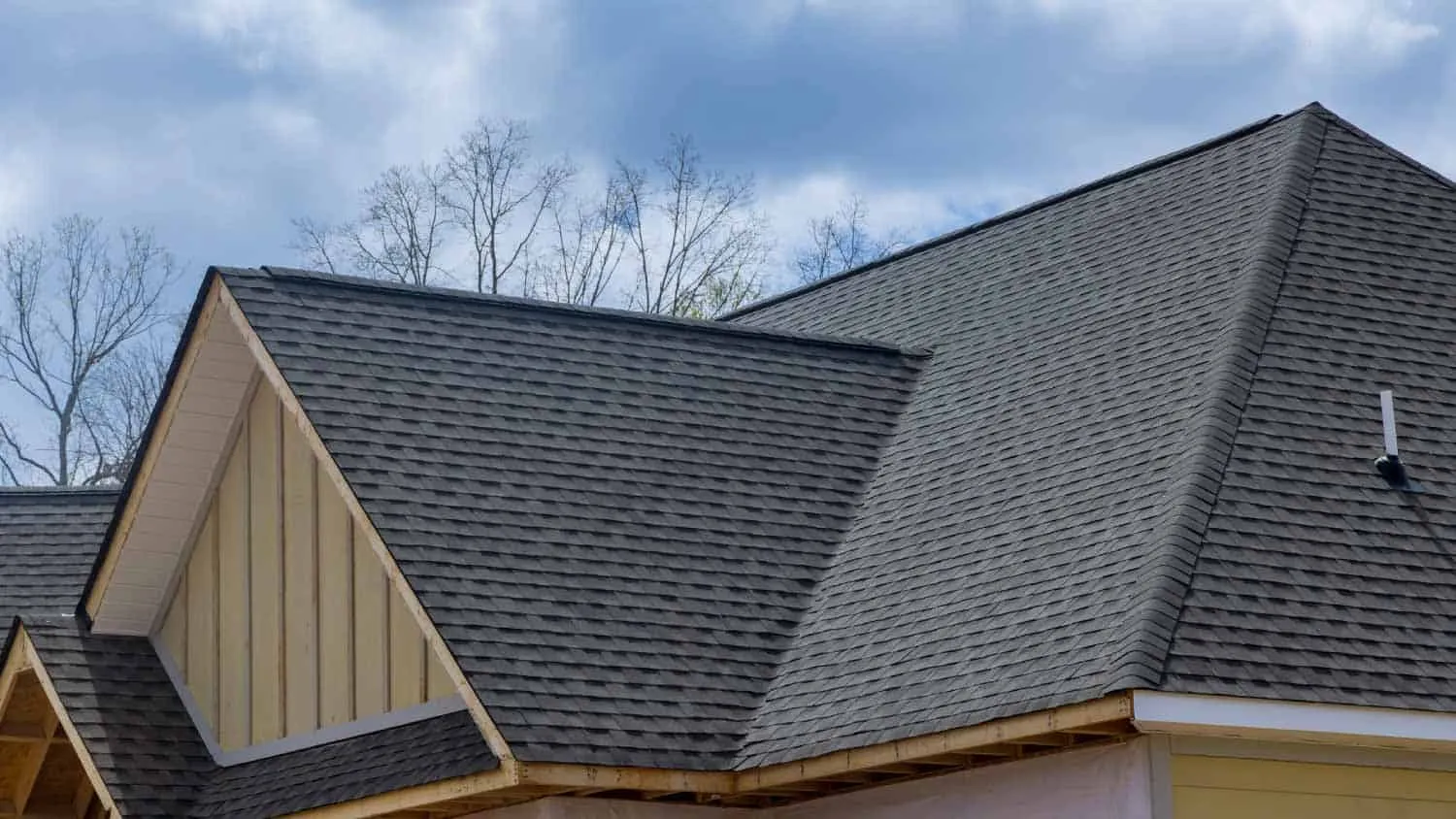 Asphalt Shingles Roof – Affordable, Durable Choice Asphalt shingle roof on a modern gable house—affordable, durable roofing material in architectural shingle profile